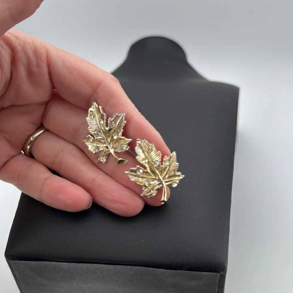 Gold tone textured leaf rhinestone accent screw back statement earrings